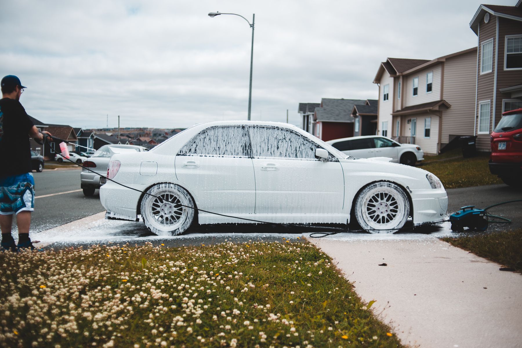 White vehicle covered in wash foam
